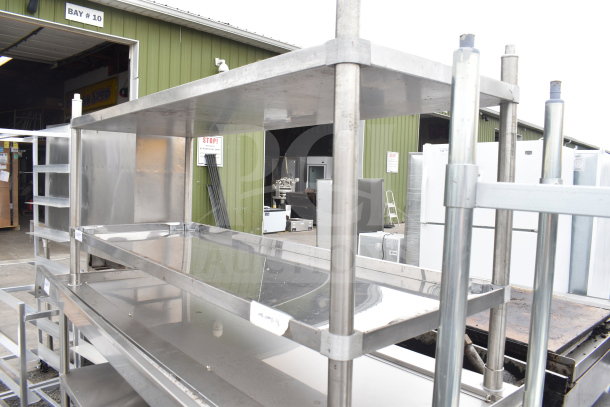 Stainless steel table with two under shelves, new with minor scratches and dents, suitable for storage or kitchen use.