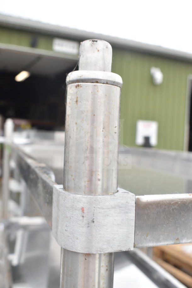 Stainless steel table with two under shelves, minor scratches and dents. Industrial setting, robust design, new condition.