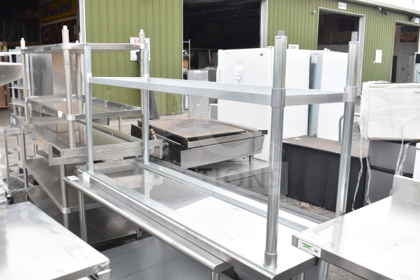 Brand new scratch and dent stainless steel table with under shelf, featuring sturdy construction and visible minor imperfections.