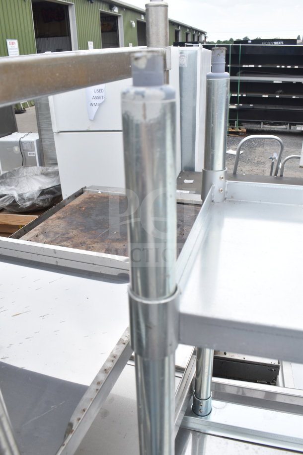Brand new scratch and dent table with under shelf, visible metal frame, minor imperfections, suitable for industrial use.