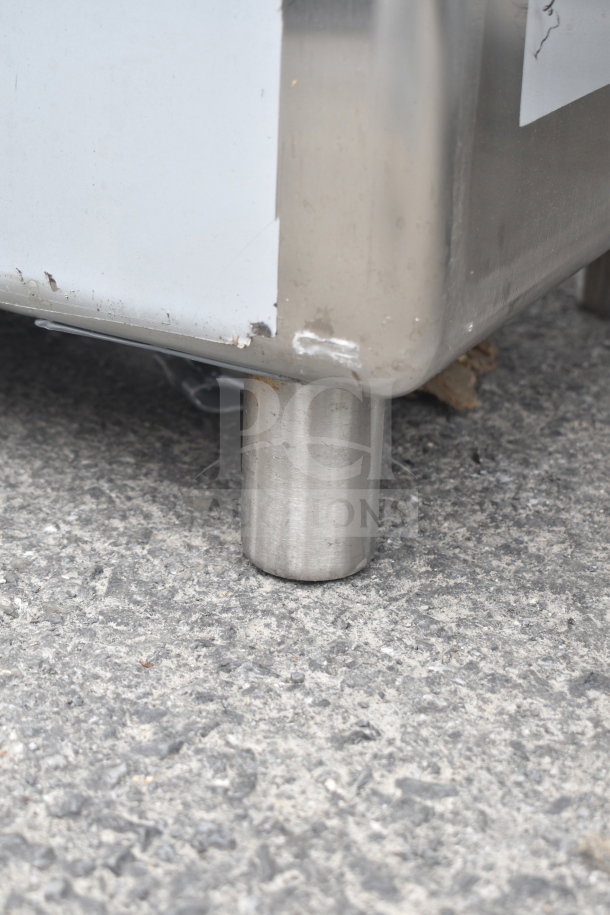 Brand new Regency 600S31818218 3 bay sink with dual drain boards, shown with minor scratches and dents on metal leg.