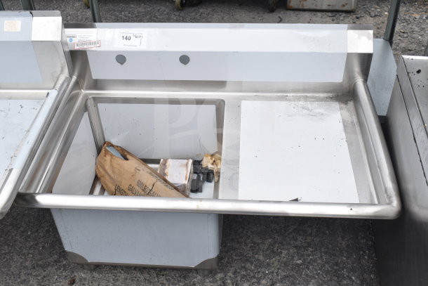 Brand new Steelton 522CS11818R commercial stainless steel sink, 18-gauge, with right drainboard, visible labels, minor scratches.