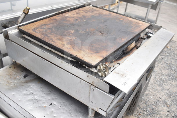 Commercial countertop gas griddle, flat top, used condition with surface wear, metal construction, visible control knob.