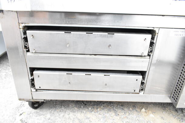Continental commercial 2-drawer chef base on casters, stainless steel, 115 volts, 1 phase. Visible wear, sturdy design.