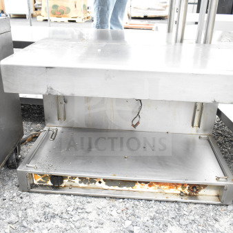 Commercial cheese melter, stainless steel, used condition with visible wear and rust, missing operational parts.