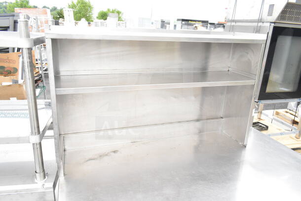 Stainless steel table with over shelf, drawer, and under shelf. Good condition, ideal for kitchen or industrial use.
