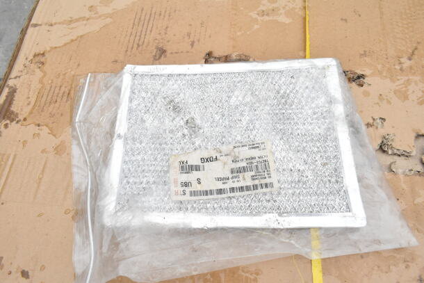 Packaged filter with shipping label, slightly crumpled, resting on a cardboard surface.