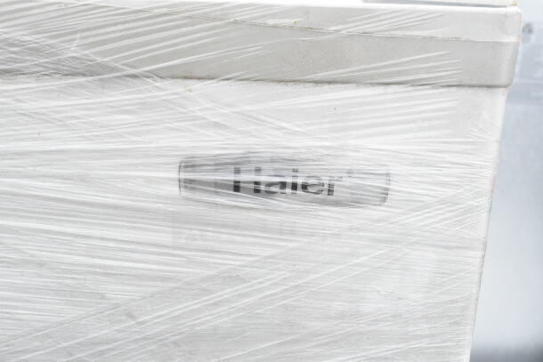 Three items: Haier and Mainstays mini coolers, Hisense chest freezer. Wrapped, visible Haier logo. 120 volts, 1 phase.