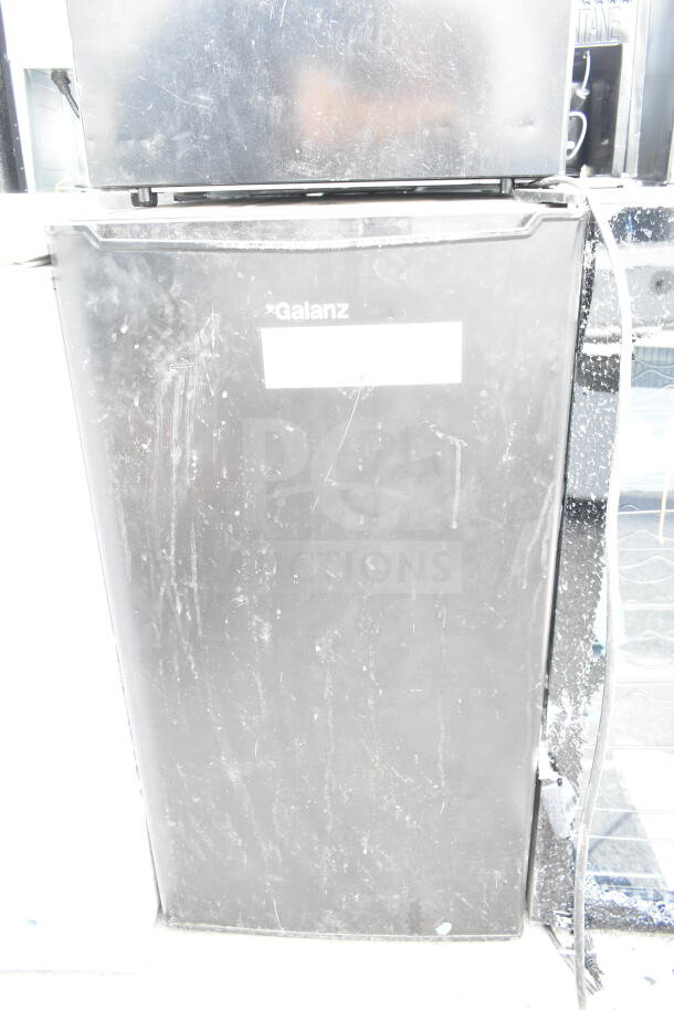 Two mini coolers, including Hisense and Galanz models. Black exterior, visible wear, 120 volts, 1 phase.