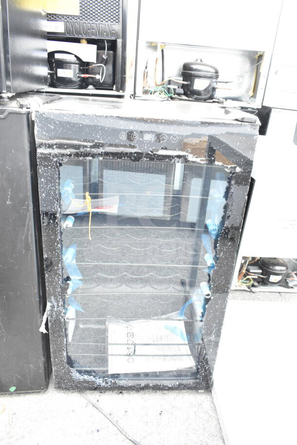 Arctic King AWCA034ADB Wine Cooler, visible glass damage, black exterior, digital controls, five wire racks inside.