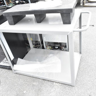Brand new gray 2-tier cart and black dunnage rack, scratch and dent items. Protective wrapping partially visible.