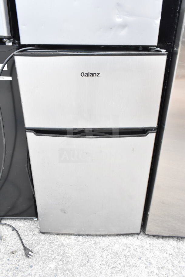 Galanz Mini Cooler, stainless steel front, cord visible, used condition. Part of 3-item auction including Frigidaire Freezer.
