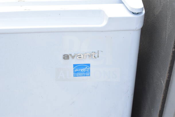 Avanti mini cooler with Energy Star certification, white, Kenmore make, visible logo. 115V, 1 phase. Auction includes Frigidaire freezer.