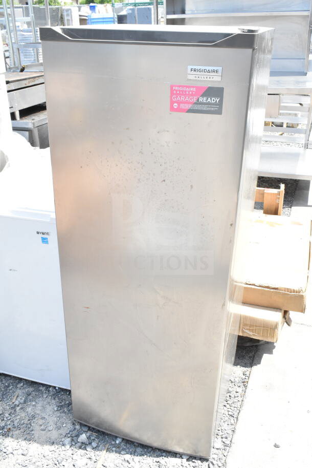 Frigidaire Gallery freezer, garage-ready sticker, stainless steel, minor surface wear, alongside Avanti mini cooler.