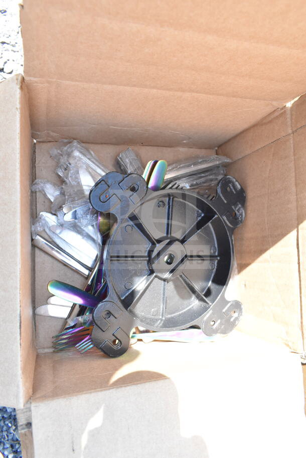 Open box with assorted stainless steel items and black plastic base, part of an 18-piece scratch and dent auction set.