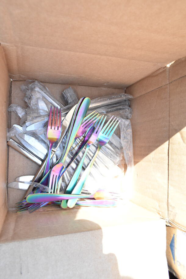 Box of new iridescent forks and knives. Multicolored finish, in protective wrap. Scratch and dent sale.