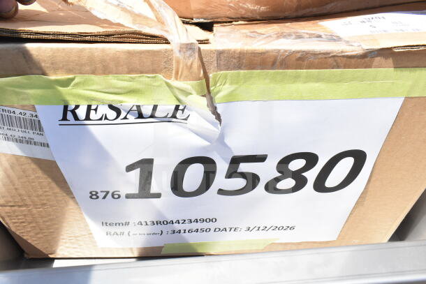Cardboard box labeled "Resale" with item number 10580, containing 18 scratch and dent items, including Speed Rail and canopy tent.