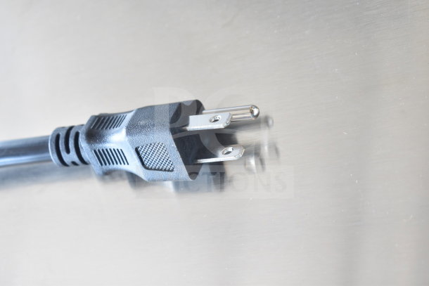 Power plug of Avantco 177LT93 stainless steel food dehydrator, 120 volts, visible on a light surface.