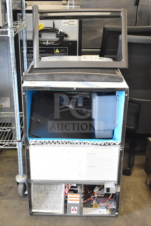 Brand new Manitowoc UDP0080A-161 ice machine, air cooled, 31 lb. bin, 110 lb. capacity, visible internal components, tags attached.