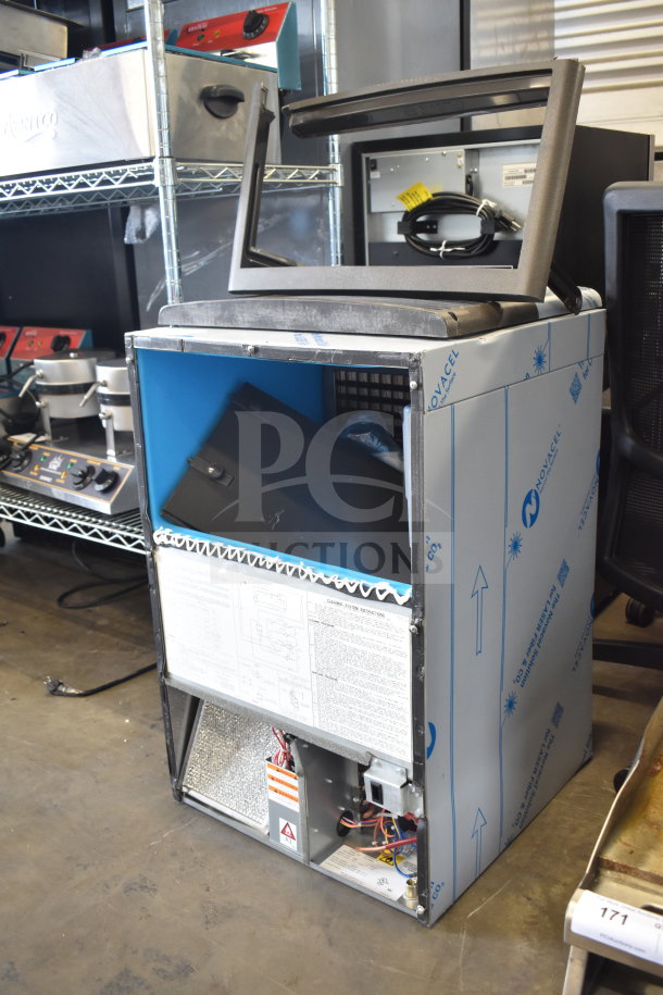 Brand new Manitowoc UDP0080A-161 ice machine, 19 11/16", air-cooled, with 31 lb. bin, some scratches, model labels visible.