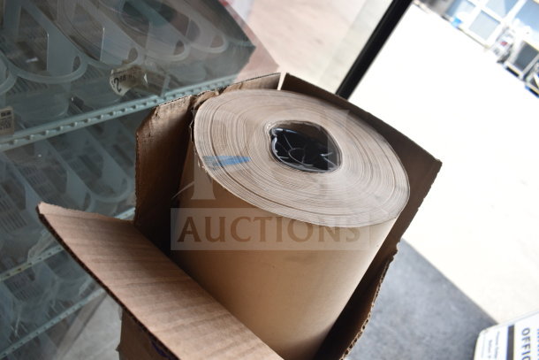 Large roll of brown paper, brand new, slight scratch and dent, in original cardboard packaging.