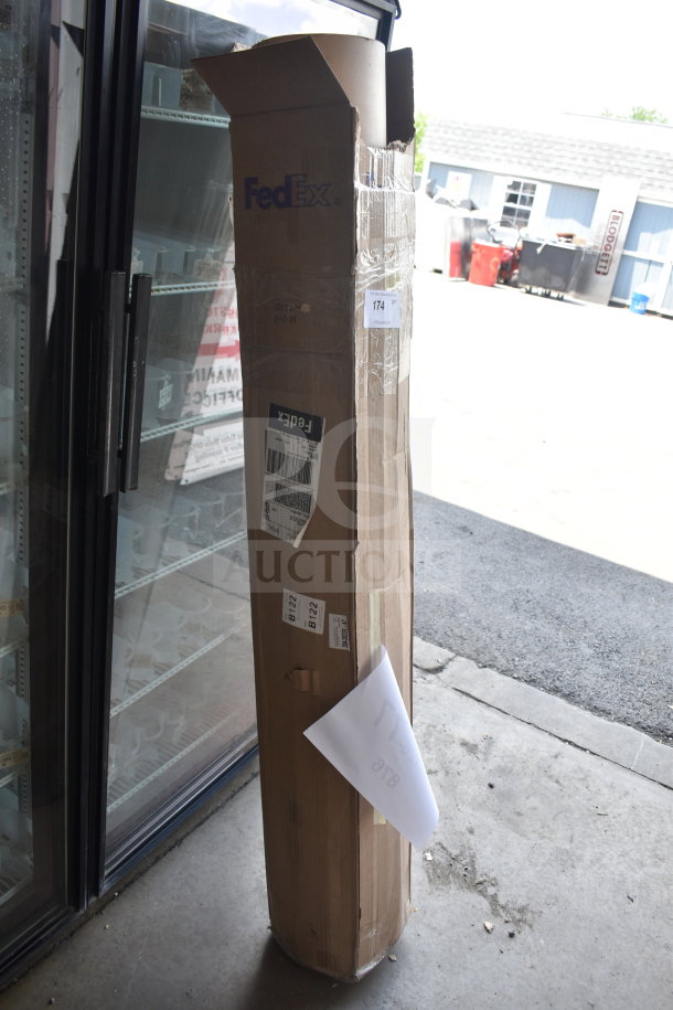 Roll of brown paper in a FedEx box, slightly damaged. Box features shipping labels and auction tag number 174.