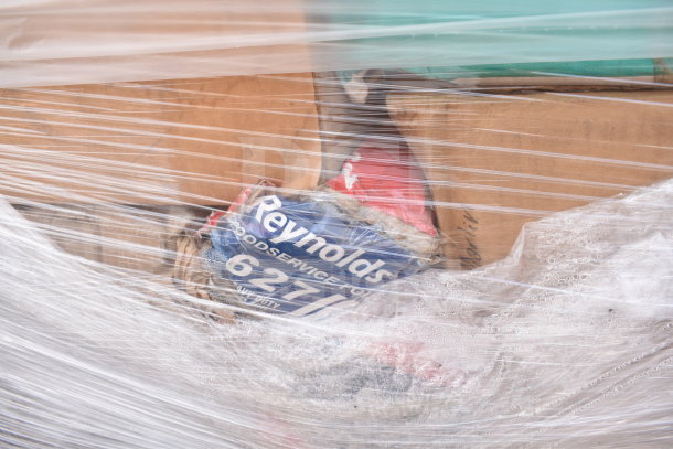 Plastic-wrapped pallet of scratch and dent items. Includes 30 items, such as Reynolds 627 foil, visible through wrap.