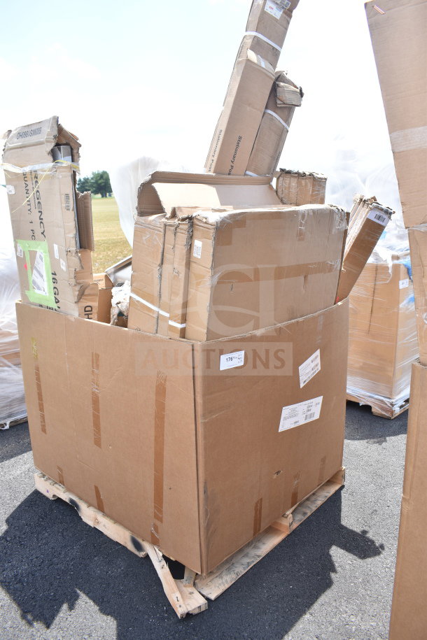 Box of 14 scratch and dent items including sinks and wall shelves on a pallet. Visible shipping labels and markings.