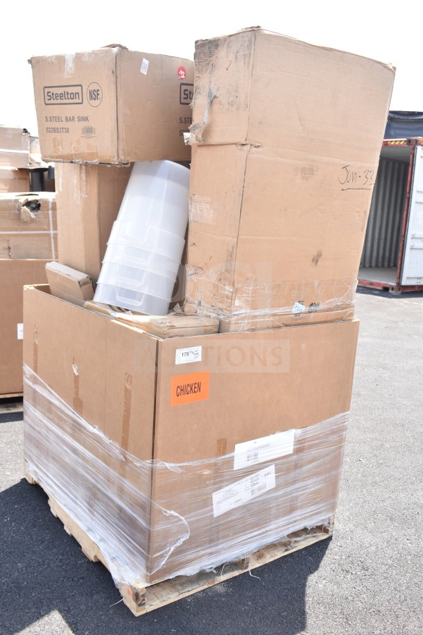 Large pallet with cardboard boxes of mixed kitchen items, labeled "Steelton NSF" and "CHICKEN." Includes door and steam table pans.