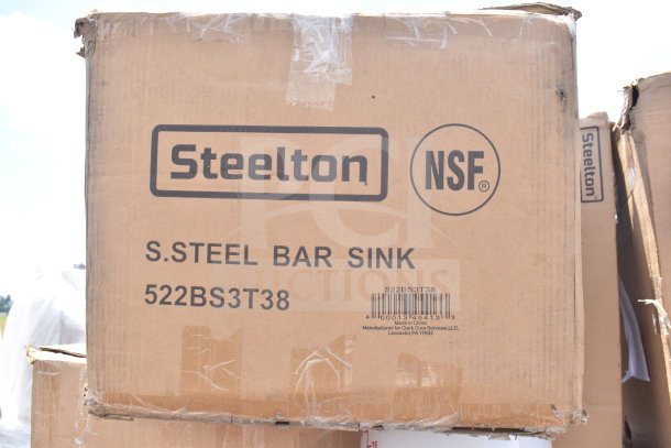 Cardboard box labeled "Steelton NSF S.Steel Bar Sink 522BS3T38," indicating contents. Box shows mild wear.