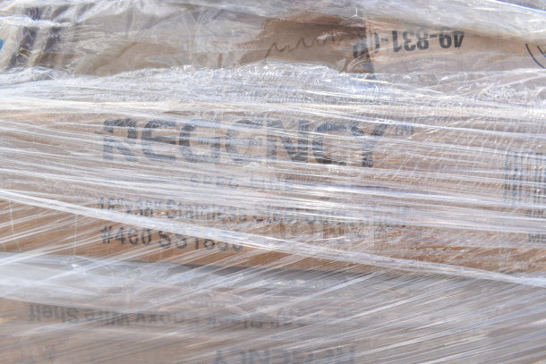 Plastic-wrapped box labeled "Regency," containing 22 brand new scratch and dent items: knives, spoons, pitcher, and plates.