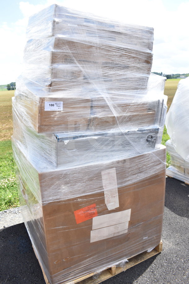 Pallet of 15 brand new scratch and dent items, including butcher block tabletops, wrapped in plastic for protection.