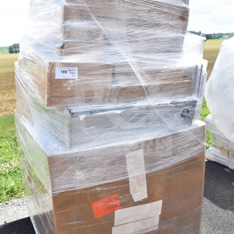 Pallet of 15 brand new scratch and dent items, including butcher block tabletops, wrapped in plastic for protection.