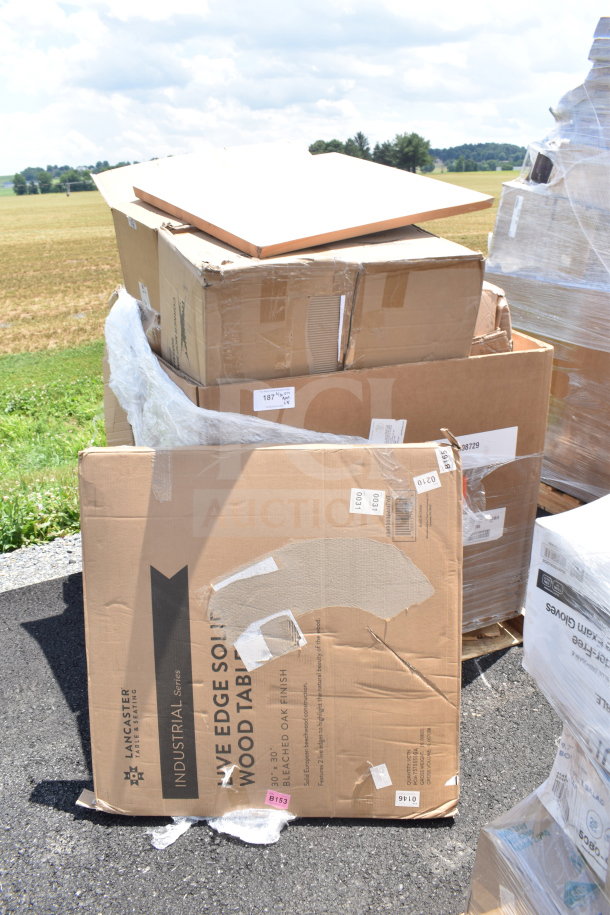 18 new scratch and dent items in boxes, including a Lancaster table, stacked outdoors on a pallet. Tags indicate item details.
