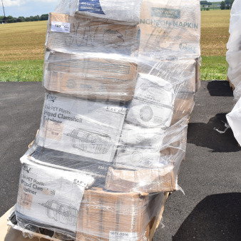 Pallet of 24 brand new scratch and dent items, including clamshell containers, napkins, and plates, sealed in wrapping.