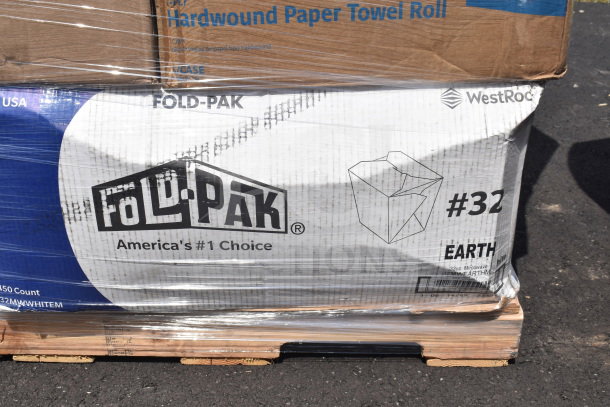 Shrink-wrapped pallet with boxes of Fold-Pak containers and paper towel rolls. Boxes labeled "America's #1 Choice" and "#32 EARTH".