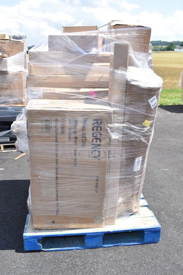 Pallet of 35 new scratch and dent items, including Regency work table boxes, wrapped in plastic, on a blue pallet.