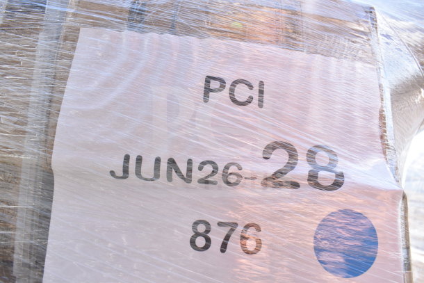 Clear wrapped pallet labeled "PCI JUN26-28" containing brand new scratch and dent items, including a shelf kit, fast food trays, glasses; auction lot of 36.