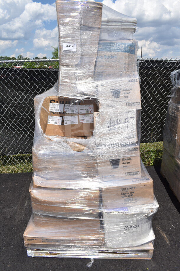 Plastic-wrapped pallet with various items including boxes labeled for pots, plates, juice cups, and forks. Scratch and dent condition.