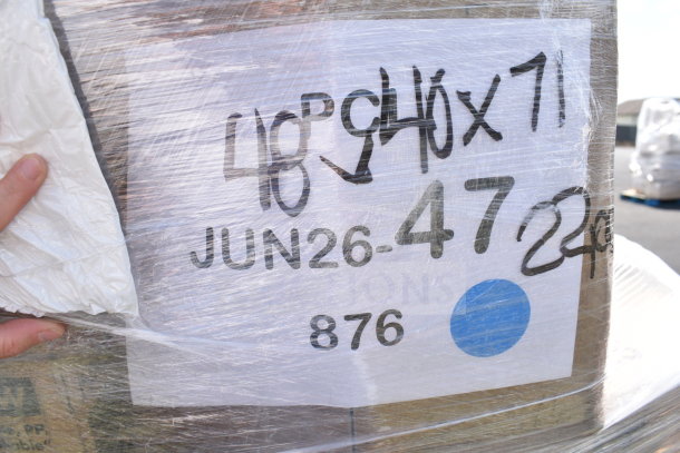 Wrapped pallet labeled "JUN26-47" with assorted scratch and dent items including mats, pot covers, plates, forks.