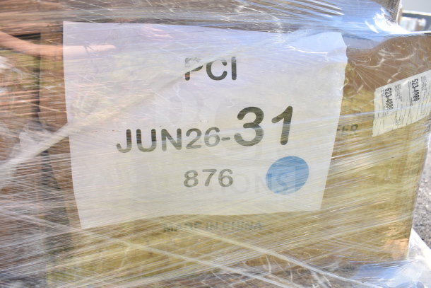 Pallet wrapped with plastic showing label "PCI JUN26-31 876," containing assorted new scratch and dent items.