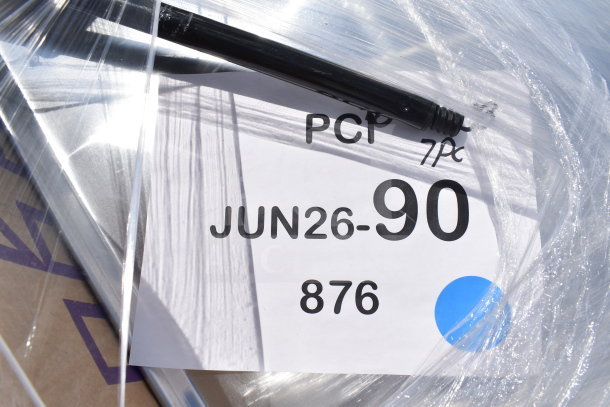 "12 scratch and dent items, including a basket, cake display container, and wall shelf. Label reads 'JUN26-90, 876'."