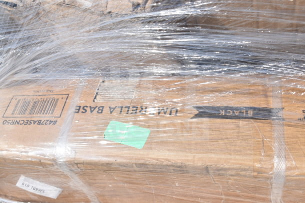 Packaged auction items including umbrella base, floor mat, and sink. Box shows "UMBRELLA BASE" marked "BLACK" and a barcode.