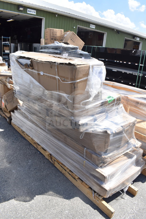 Pallet of 6 brand new items, scratch and dent, including a work table and air curtain, wrapped in plastic, outdoor warehouse setting.