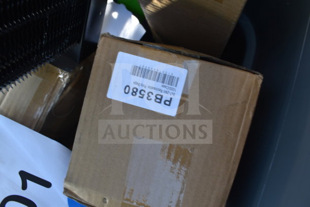 Cardboard box with barcode label, part of 9 brand new scratch and dent items, including a trash can and plates.