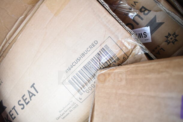 Boxes marked with "Bucket Seat" and "#164CUSHBUCRED," indicating new scratch and dent items, including a seat cushion and rack.