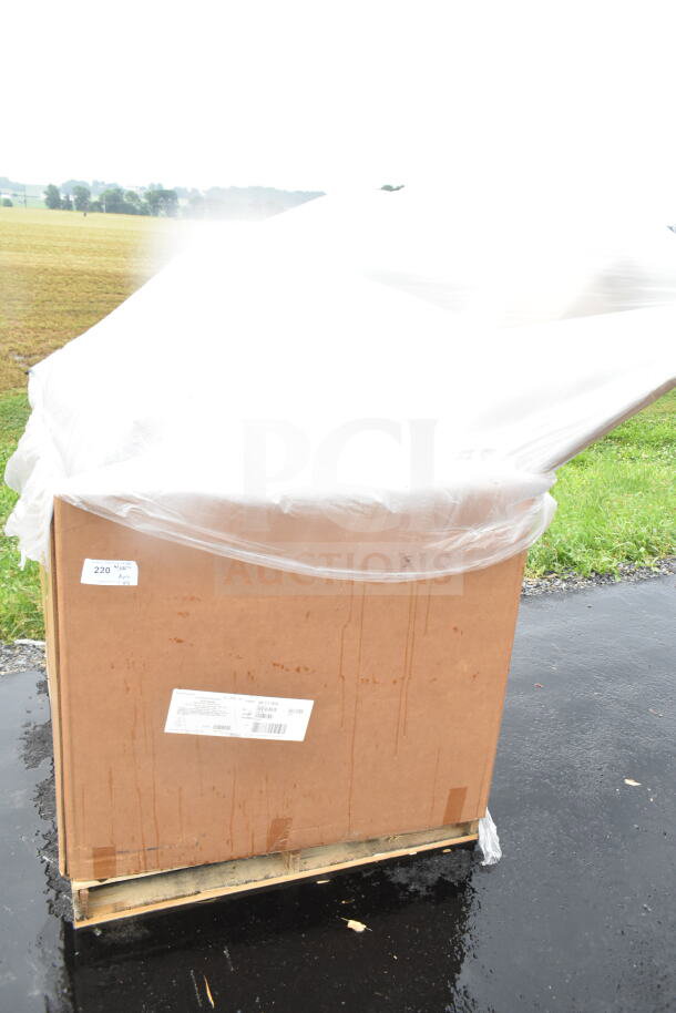 Large cardboard box covered with plastic wrap, labeled "220." Contains 12 new scratch and dent items including tray stand, plastic plates.