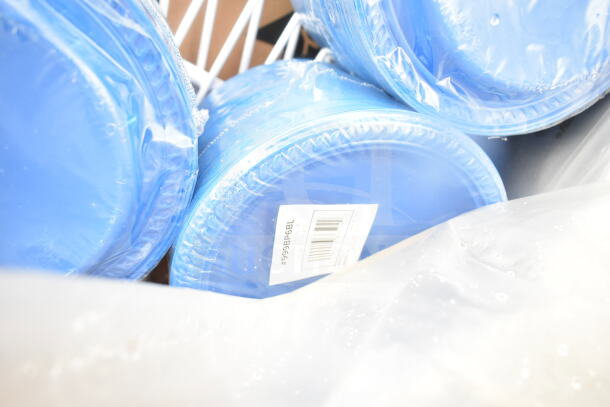 Blue plastic plates in packaging, part of a scratch and dent auction lot. Visible barcode reads '#999BP6BL'.
