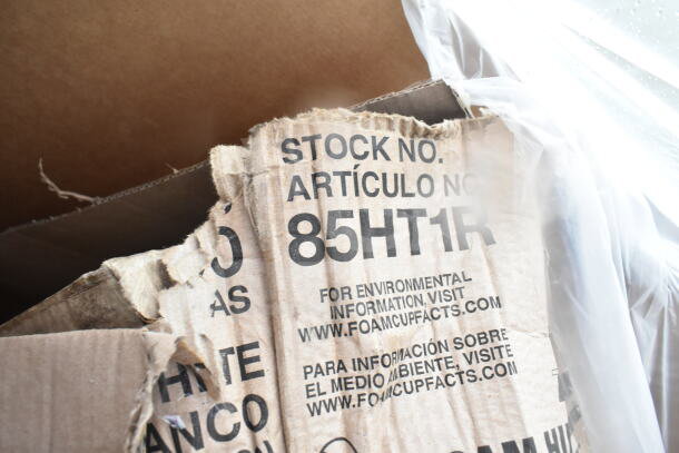 Torn cardboard box labeled "STOCK NO. 85HT1R" with environmental info. Contains scratch and dent tray stand, plastic plates.
