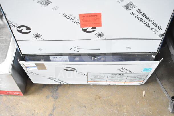 Brand new Noble 495LTUC24 undercounter dishwasher with scratches, low-temperature model, 120V, 1 phase. Protective covering visible.